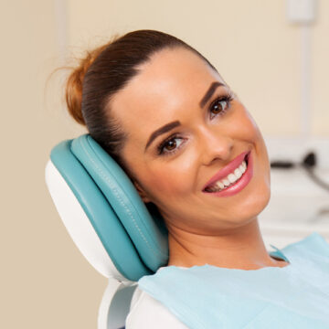 Girl seating on the Brampton dental clinic chair for dental treatment