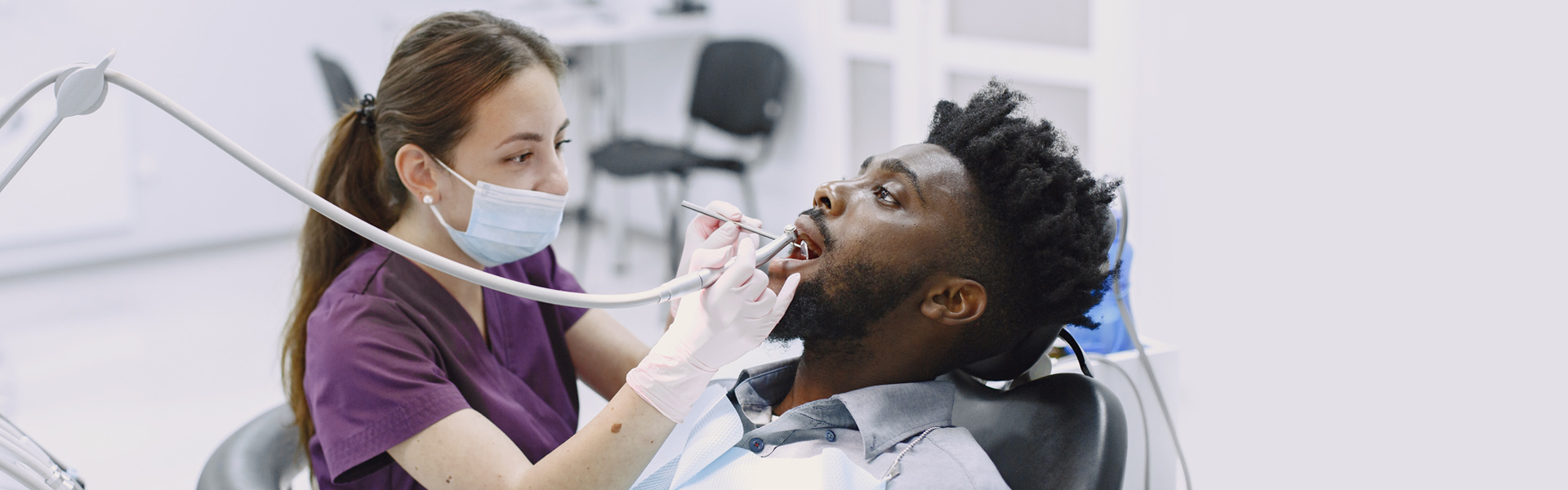 Brampton dentist doing routin dental exam & cleaning to their patient
