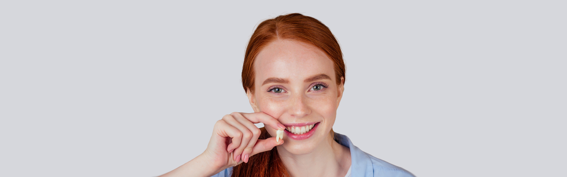 Girl holding her extracted tooth in Brampton